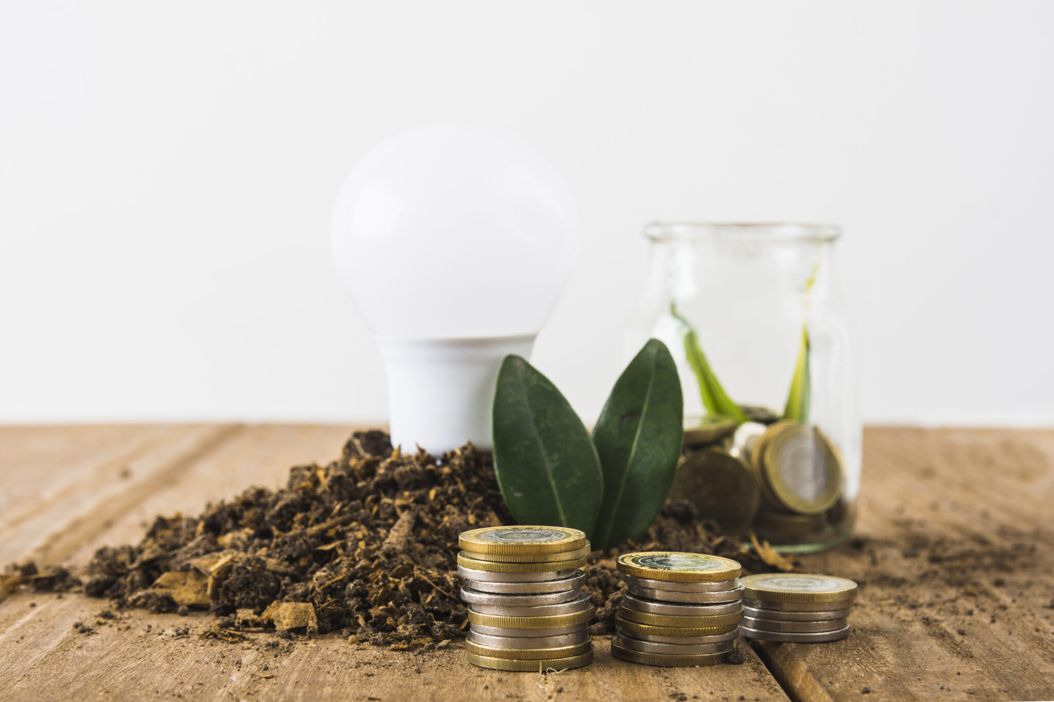 coins stack with light bulb jar scaled